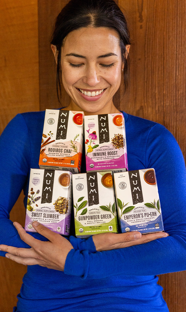woman-holding-numi-tea-boxes.jpg